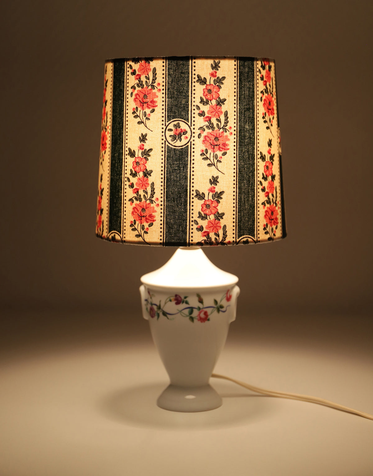 Upcycled vintage lamp — antique bronze candlestick base and graphic floral pattern