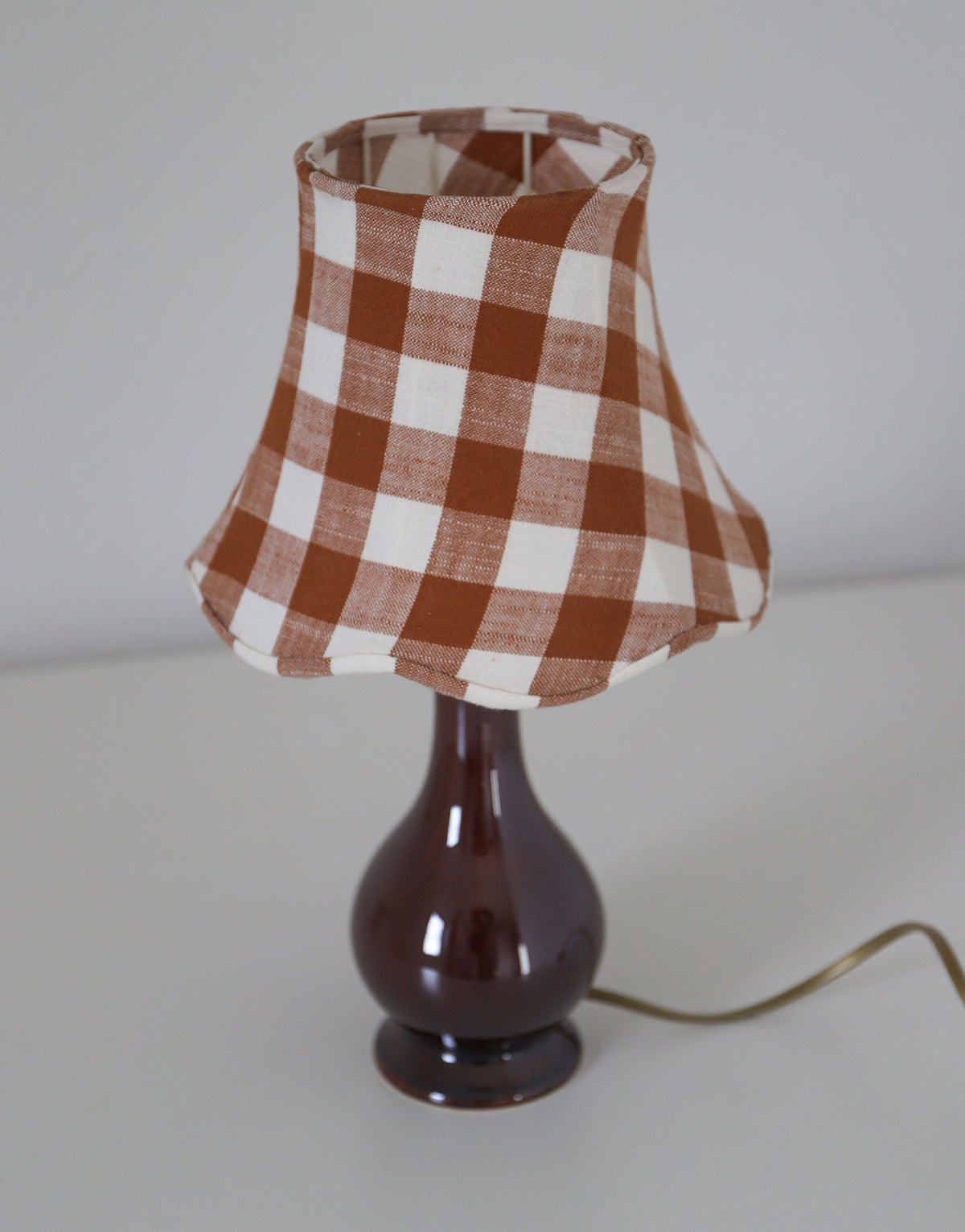Upcycled vintage lamp — antique bronze candlestick base and graphic floral pattern