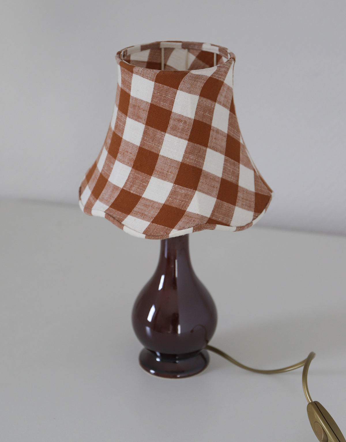 Upcycled vintage lamp — antique bronze candlestick base and graphic floral pattern