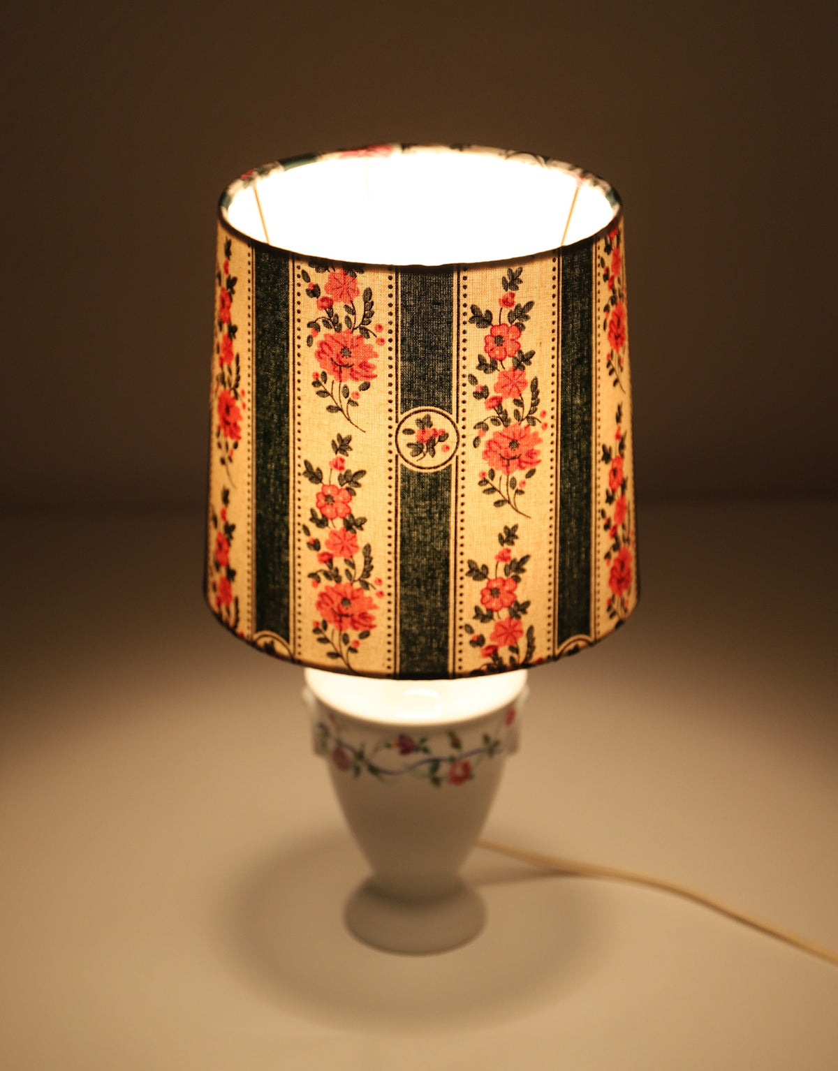 Upcycled vintage lamp — antique bronze candlestick base and graphic floral pattern