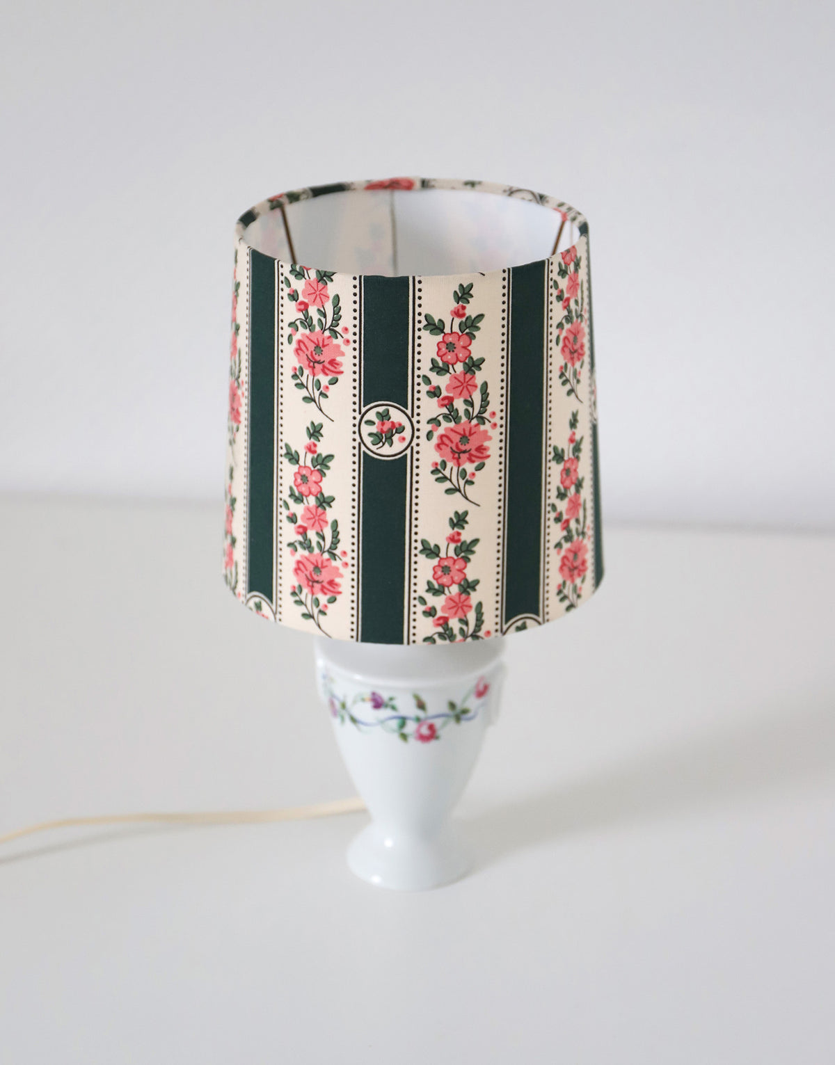 Upcycled vintage lamp — antique bronze candlestick base and graphic floral pattern