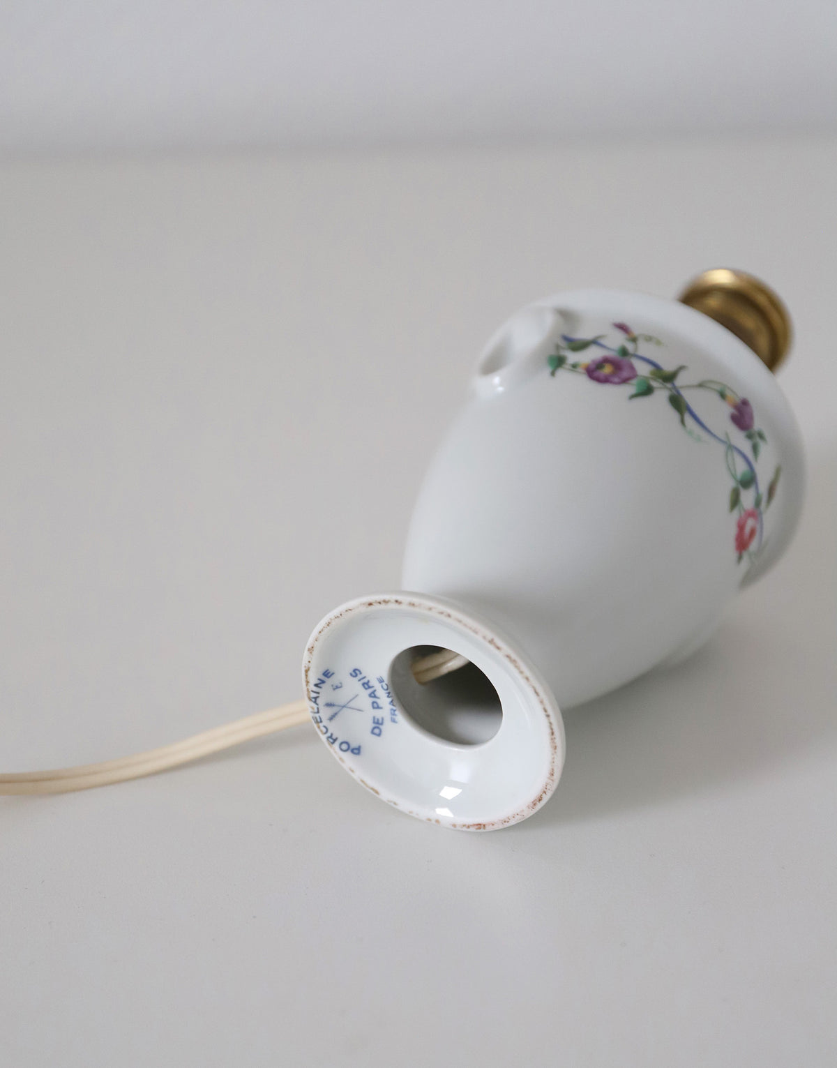 Upcycled vintage lamp — antique bronze candlestick base and graphic floral pattern