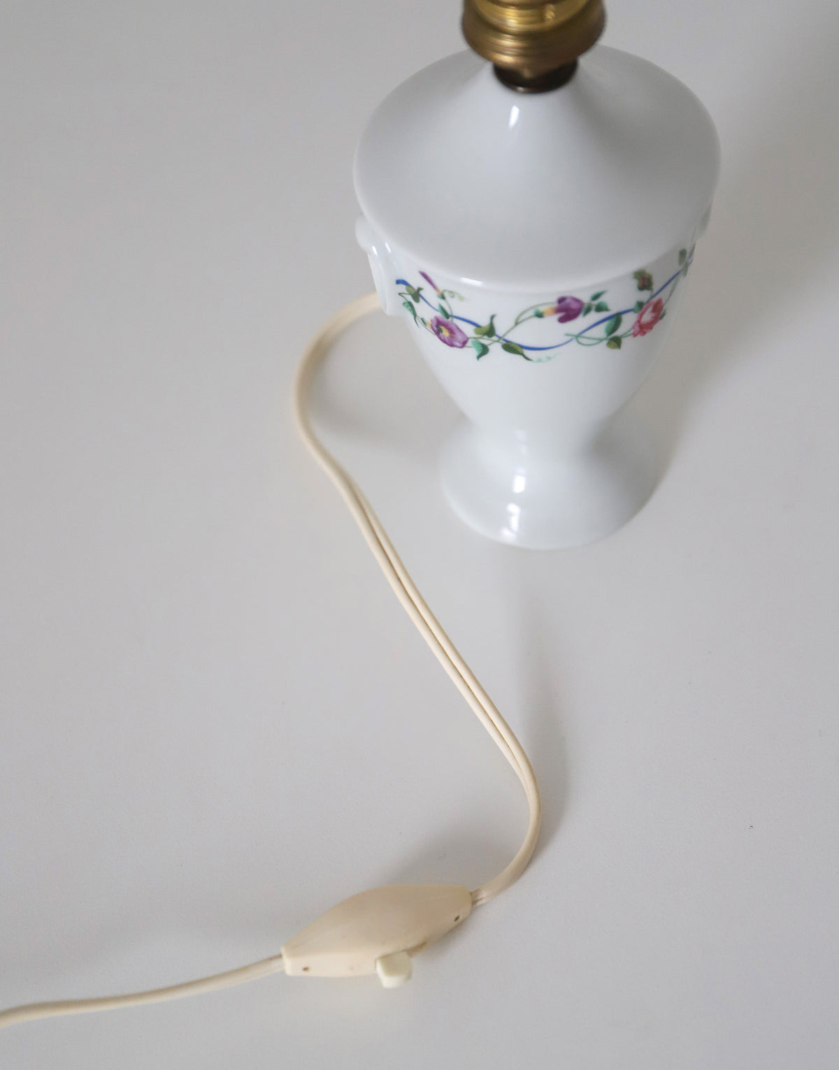 Upcycled vintage lamp — antique bronze candlestick base and graphic floral pattern