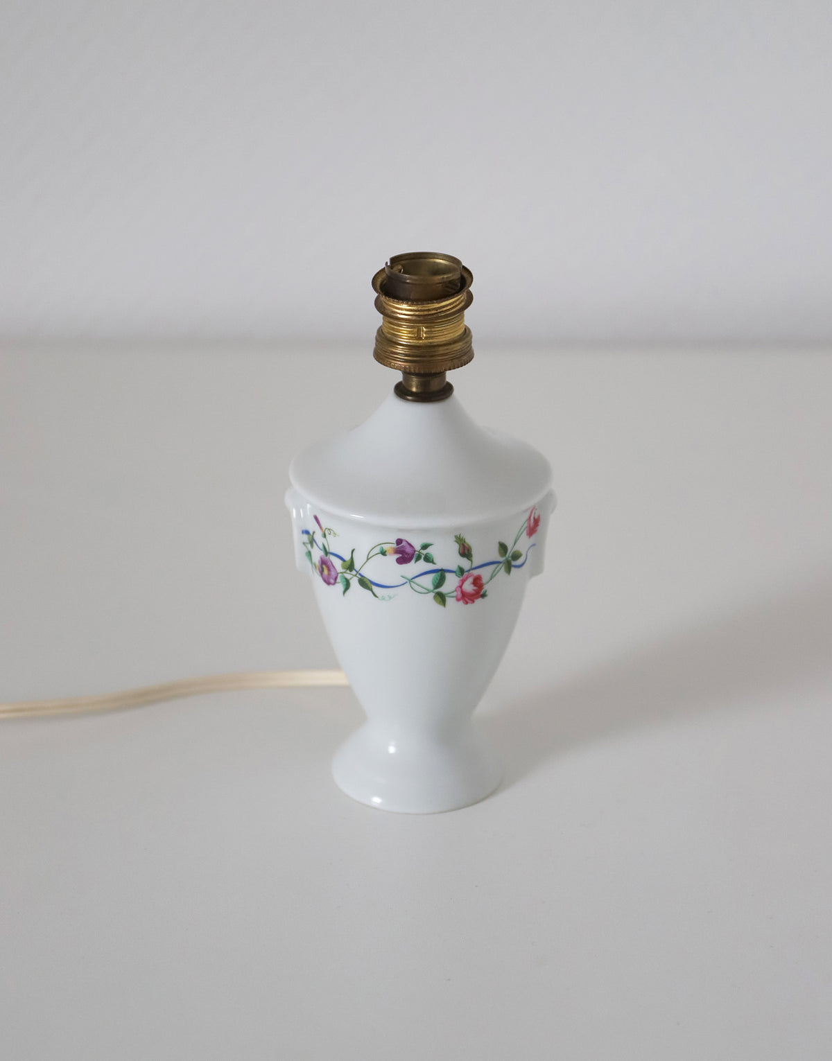 Upcycled vintage lamp — antique bronze candlestick base and graphic floral pattern